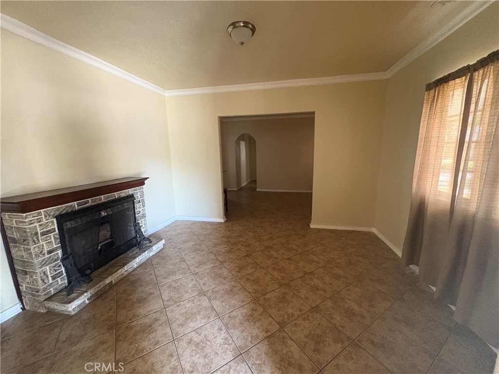 3395 Franklin Avenue Riverside, CA 92507 - Photo 7 of 55 a view of an empty room with a fireplace and a window