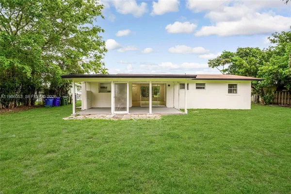 a view of a house with a backyard