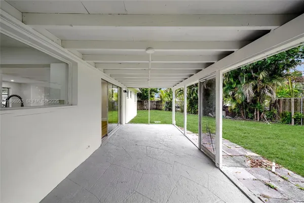 a view of a house with backyard and porch