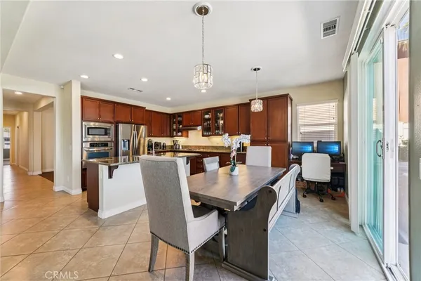 a dining room with furniture and a chandelier