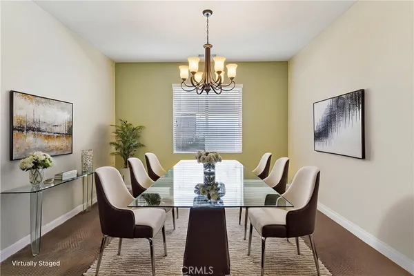 a dining room with furniture a chandelier and window