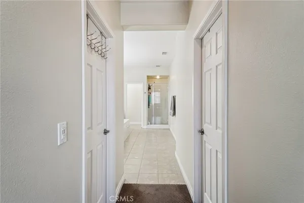 a view of a hallway with wooden floor and closet