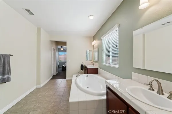 a bathroom with a sink double vanity and a mirror