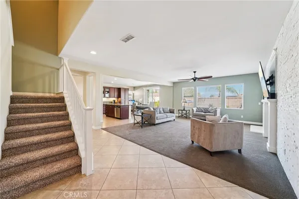 a living room with furniture and stairs