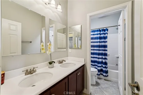 a bathroom with a sink double vanity and a mirror