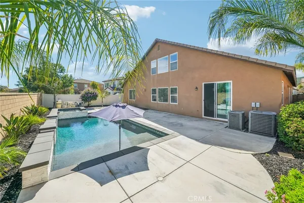 a view of a house with backyard and sitting area
