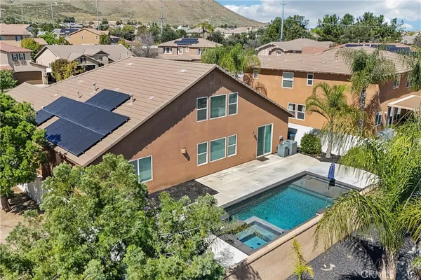 an aerial view of residential houses with outdoor space and trees