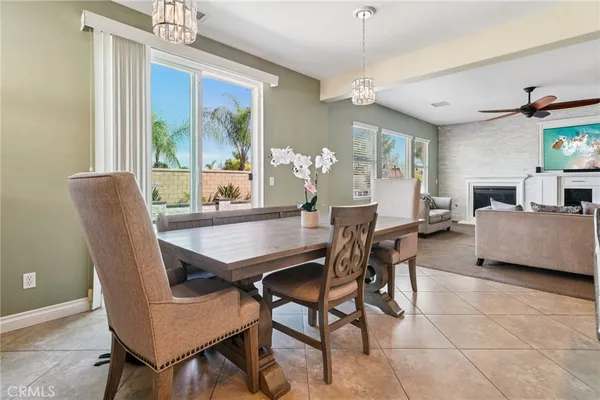 a dining room with furniture a chandelier and window