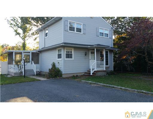 626 Spruce Road North Brunswick, NJ 08902 - Photo 1 of 23 a black and white house with a yard