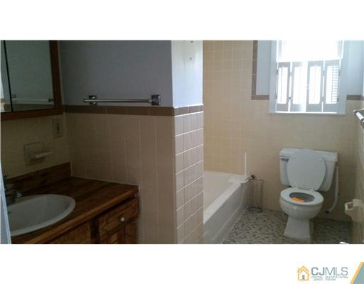 626 Spruce Road North Brunswick, NJ 08902 - Photo 18 of 23 a bathroom with a sink toilet a mirror and bathtub