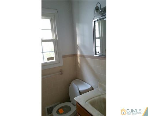 626 Spruce Road North Brunswick, NJ 08902 - Photo 8 of 23 a picture of a bathroom with sink and mirror