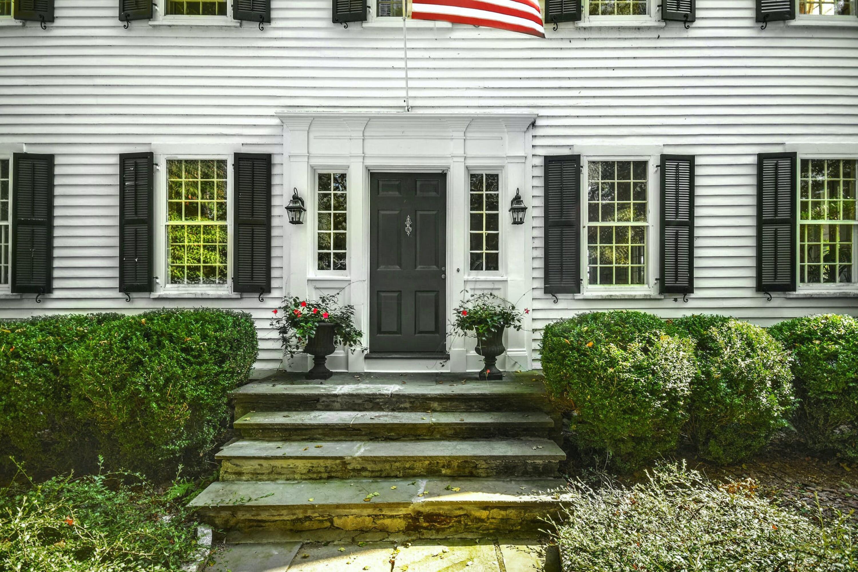 162 Marshall Ridge Road New Canaan, CT 06840 - Photo 2 of 29 a front view of a house with a garden