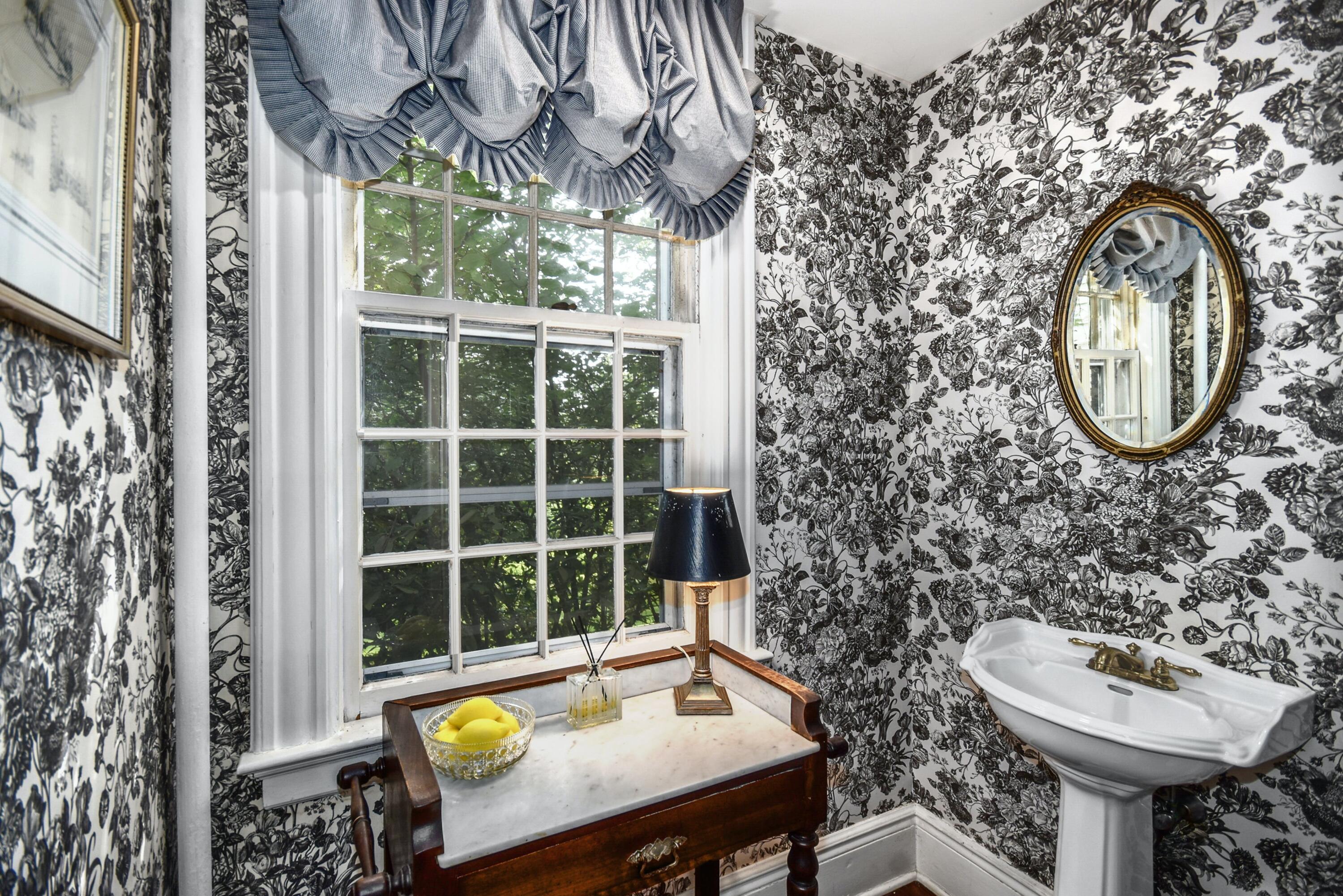 162 Marshall Ridge Road New Canaan, CT 06840 - Photo 16 of 29 a view of a bathroom with a sink and a toilet