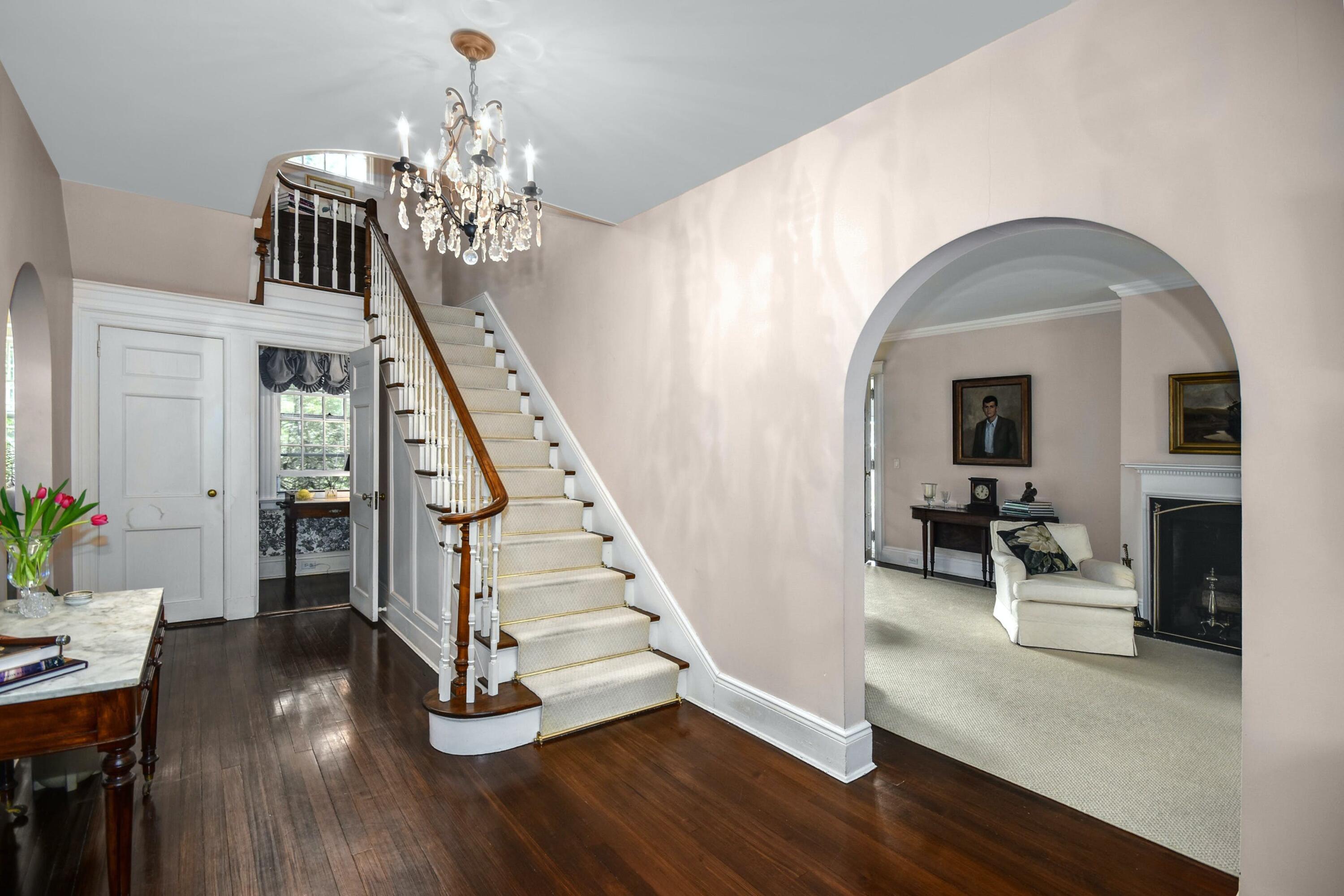 162 Marshall Ridge Road New Canaan, CT 06840 - Photo 3 of 29 a view of a livingroom with wooden floor and staircase