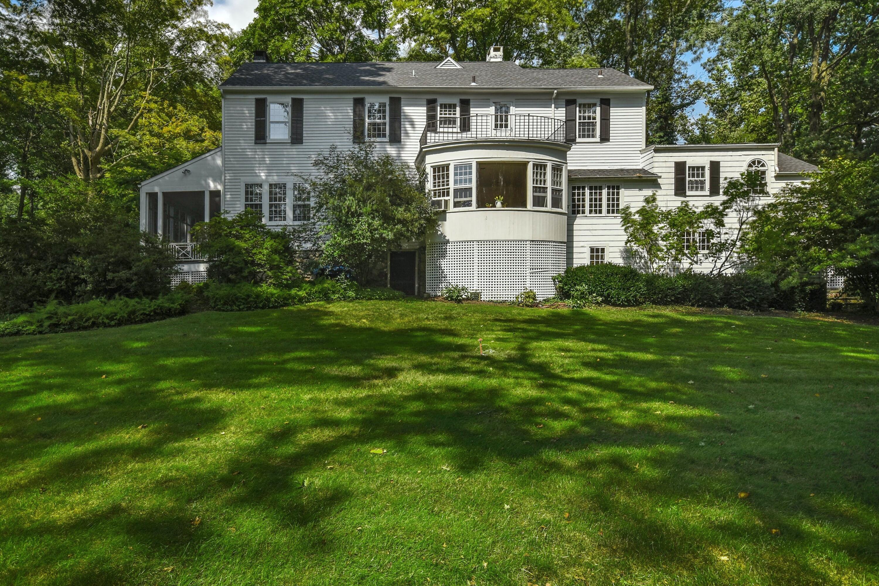 162 Marshall Ridge Road New Canaan, CT 06840 - Photo 23 of 29 a front view of a house with a garden