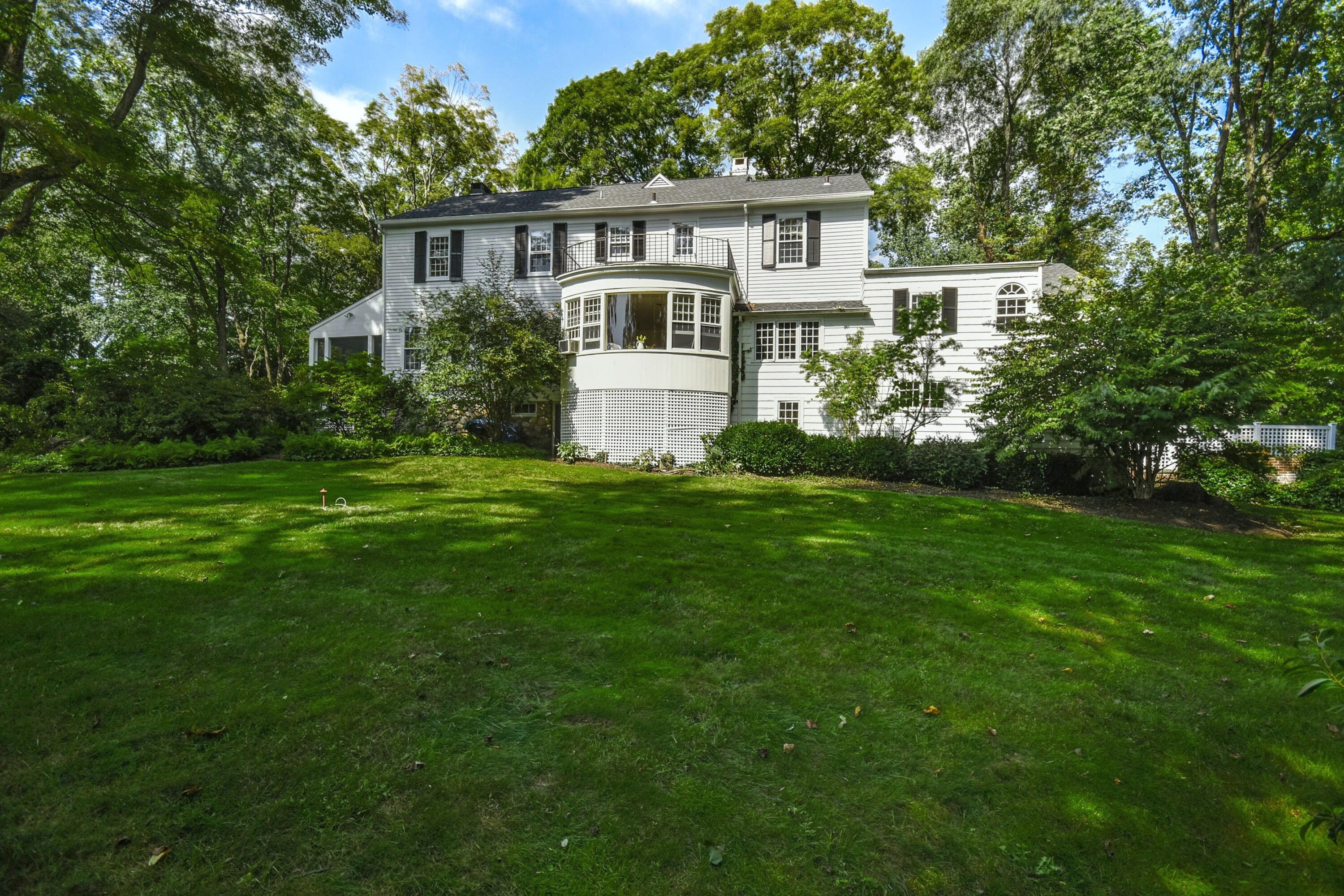 162 Marshall Ridge Road New Canaan, CT 06840 - Photo 24 of 29 a front view of a house with a yard and trees