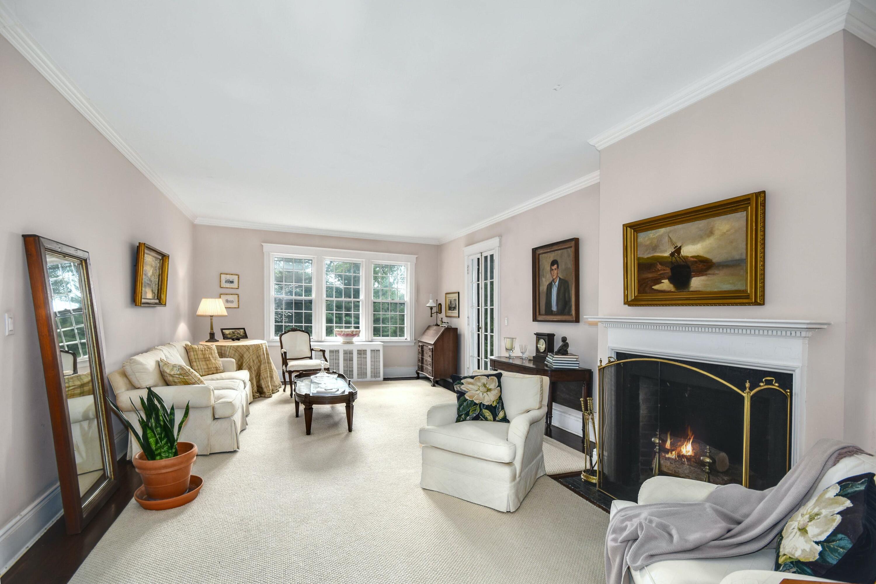 162 Marshall Ridge Road New Canaan, CT 06840 - Photo 7 of 29 a living room with furniture potted plant and a fireplace