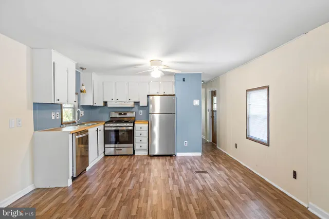 a kitchen with stainless steel appliances a stove a sink and a refrigerator