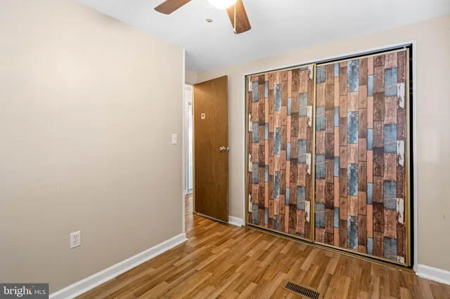 a view of a room with wooden floor and windows