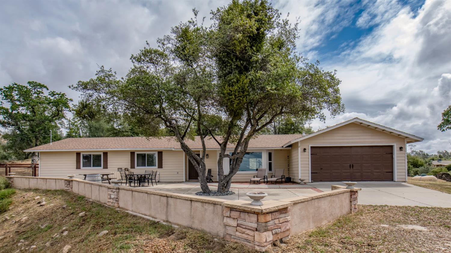 29395 Revis Road Coarsegold, CA 93614 - Photo 1 of 32 a front view of a house with yard and trees