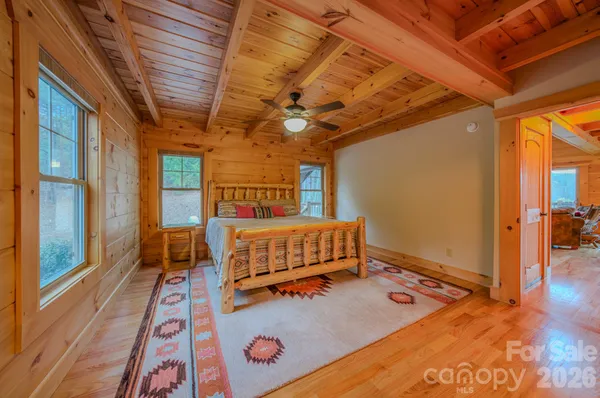 a large bed sitting in a room next to a window