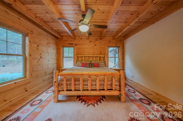 a bed sitting in a bedroom next to a window