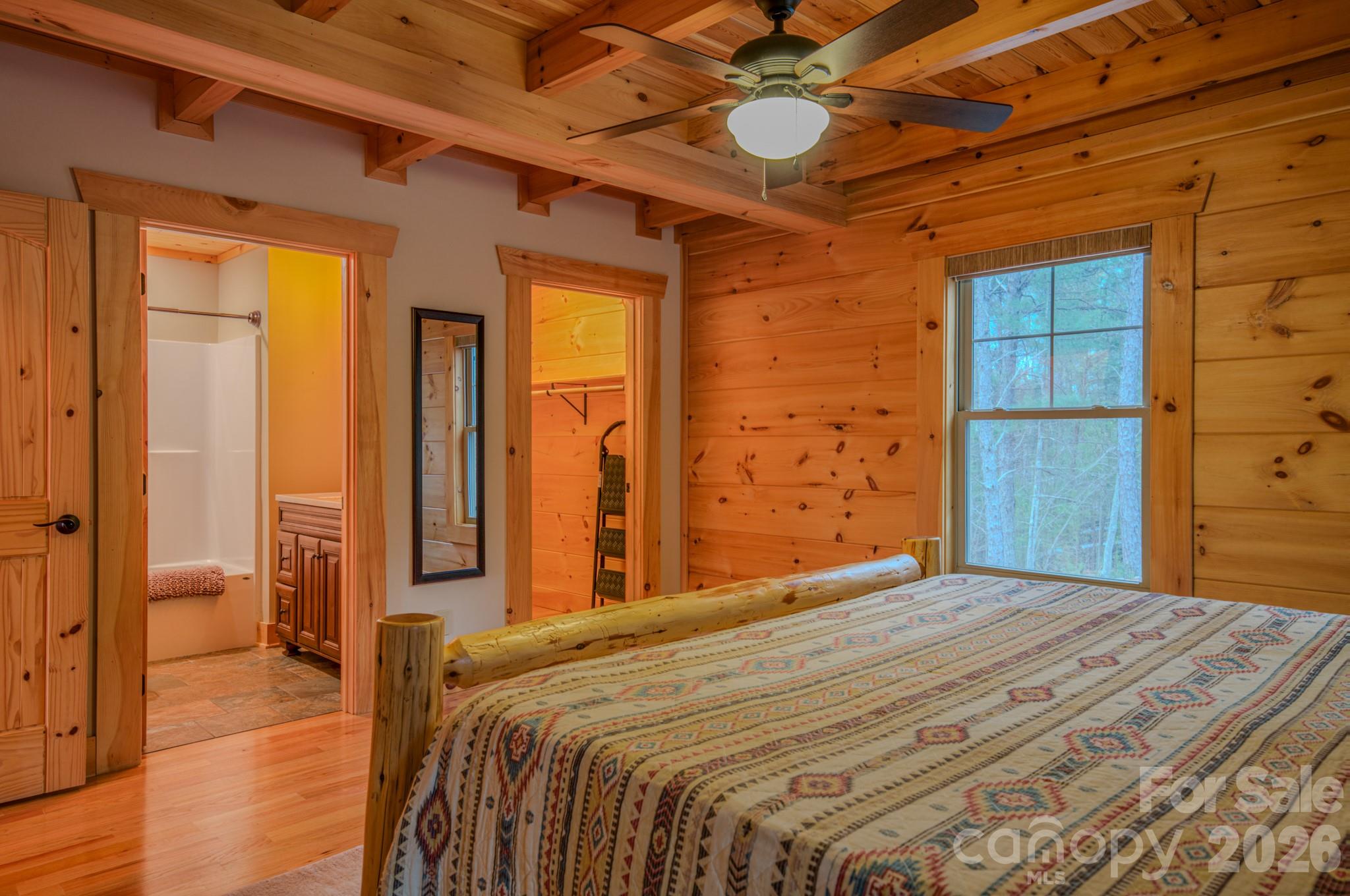 9147 Shortoff View Terrace Nebo, NC 28761 - Photo 23 of 48 a bedroom with a bed and a chandelier