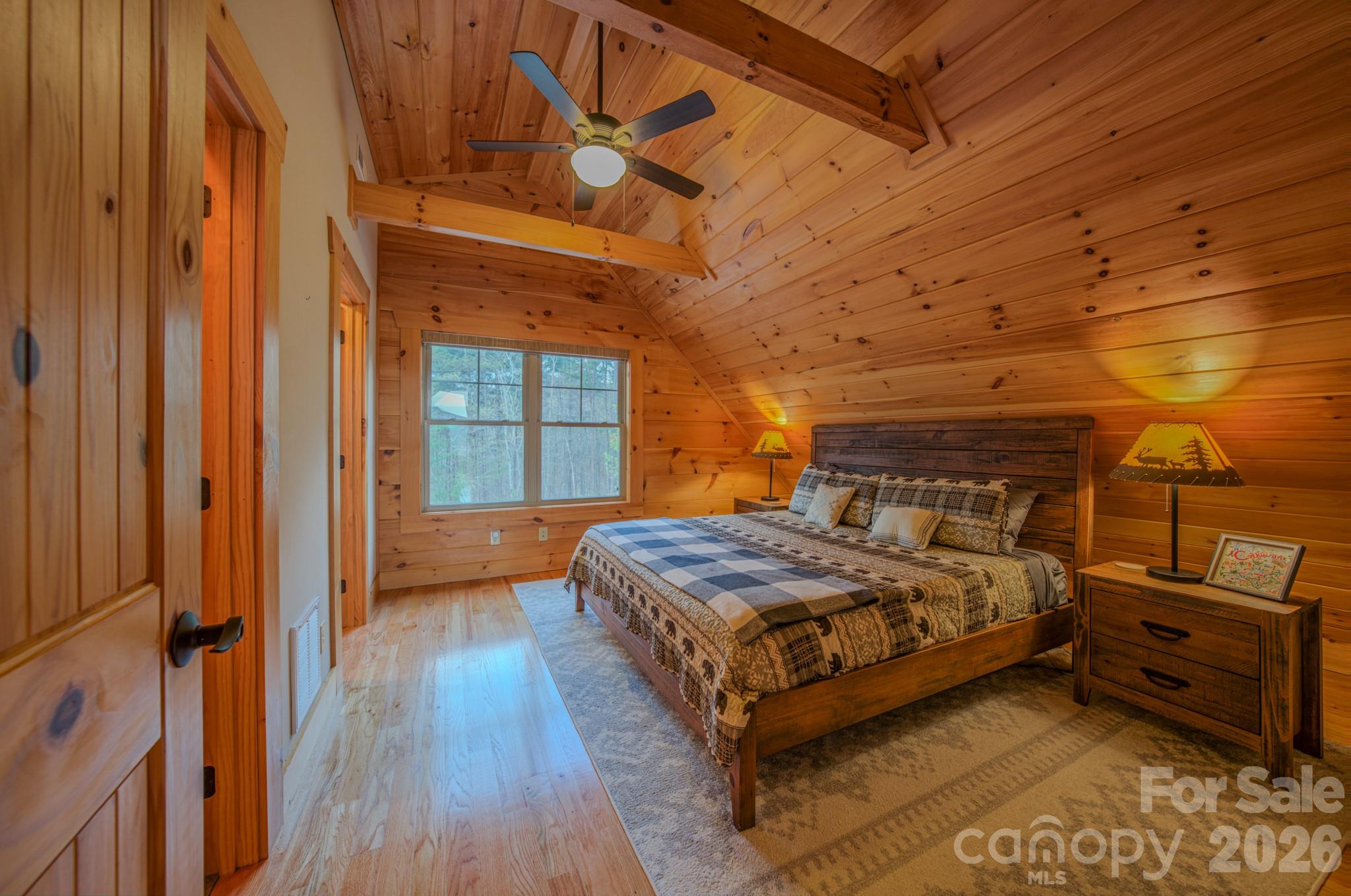 9147 Shortoff View Terrace Nebo, NC 28761 - Photo 24 of 48 a bedroom with a bed and wooden floor