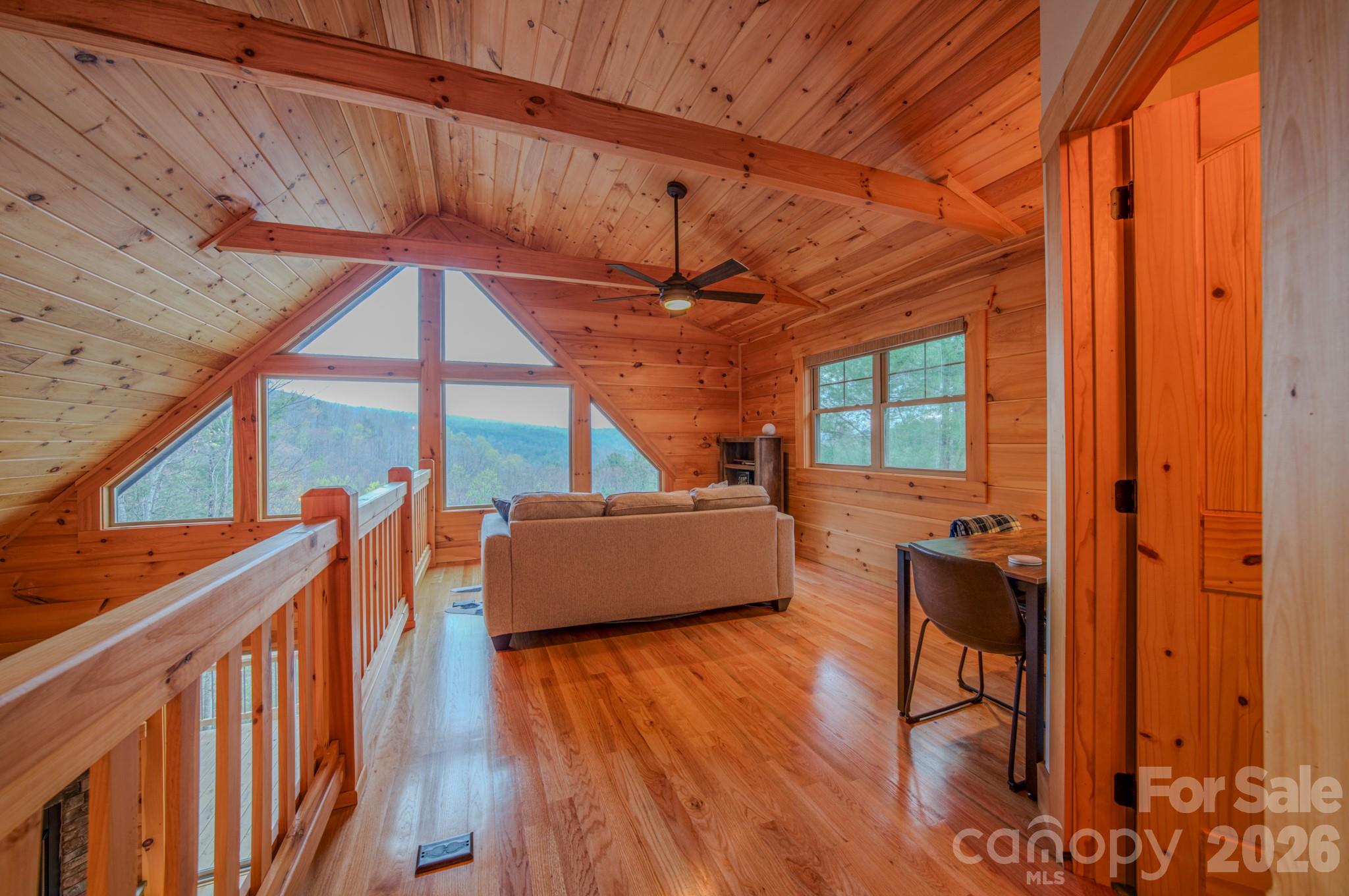 9147 Shortoff View Terrace Nebo, NC 28761 - Photo 25 of 48 a room with lots of wooden furniture and windows