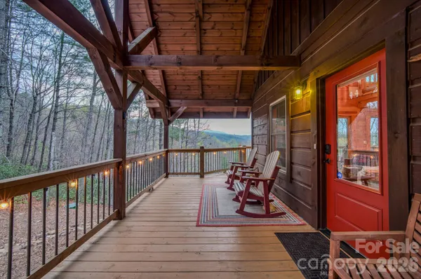 a view of a porch with furniture and wooden floor