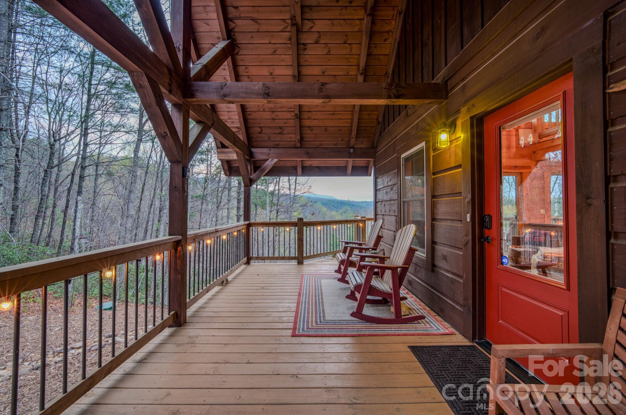9147 Shortoff View Terrace Nebo, NC 28761 - Photo 9 of 48 a view of a porch with furniture and wooden floor