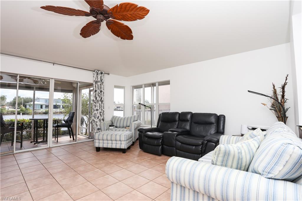 162 Eveningstar Cay Naples, FL 34114 - Photo 12 of 32 a living room with furniture and a large window