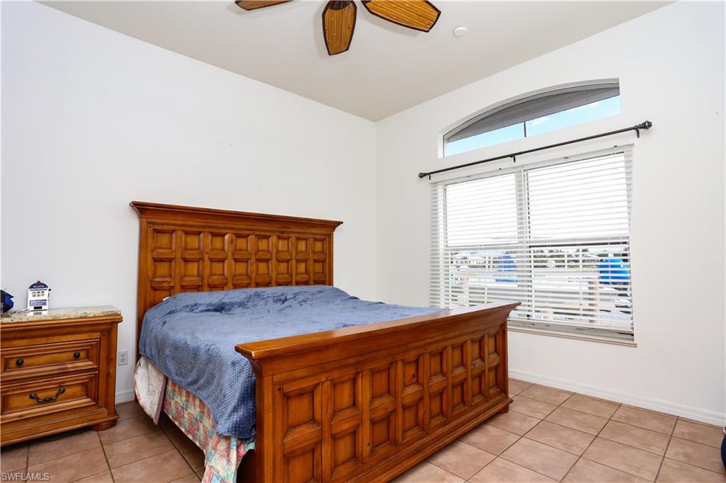 162 Eveningstar Cay Naples, FL 34114 - Photo 14 of 32 a bedroom with a bed and window