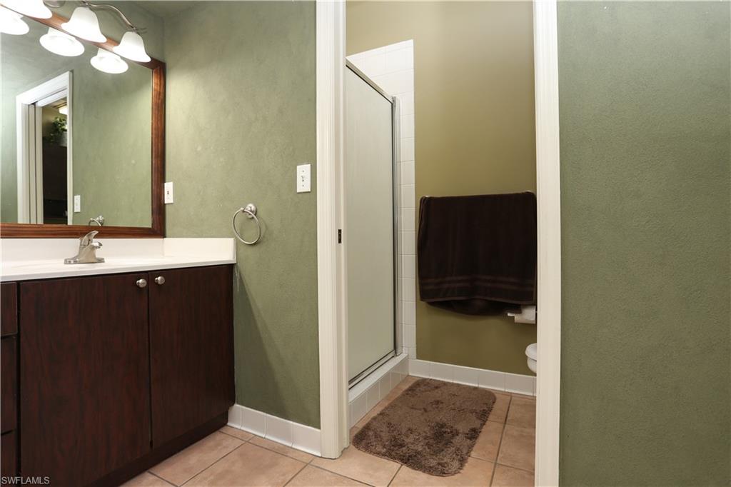 162 Eveningstar Cay Naples, FL 34114 - Photo 16 of 32 a bathroom with a sink and a mirror