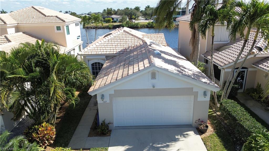 162 Eveningstar Cay Naples, FL 34114 - Photo 2 of 32 a view of a house with a yard
