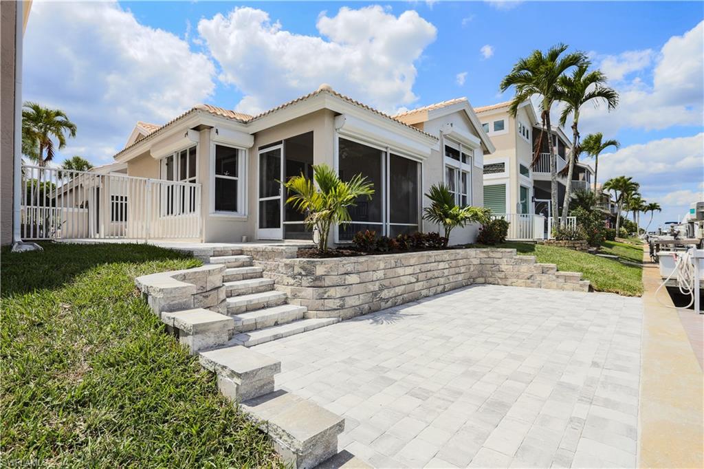162 Eveningstar Cay Naples, FL 34114 - Photo 21 of 32 a front view of a house with garden