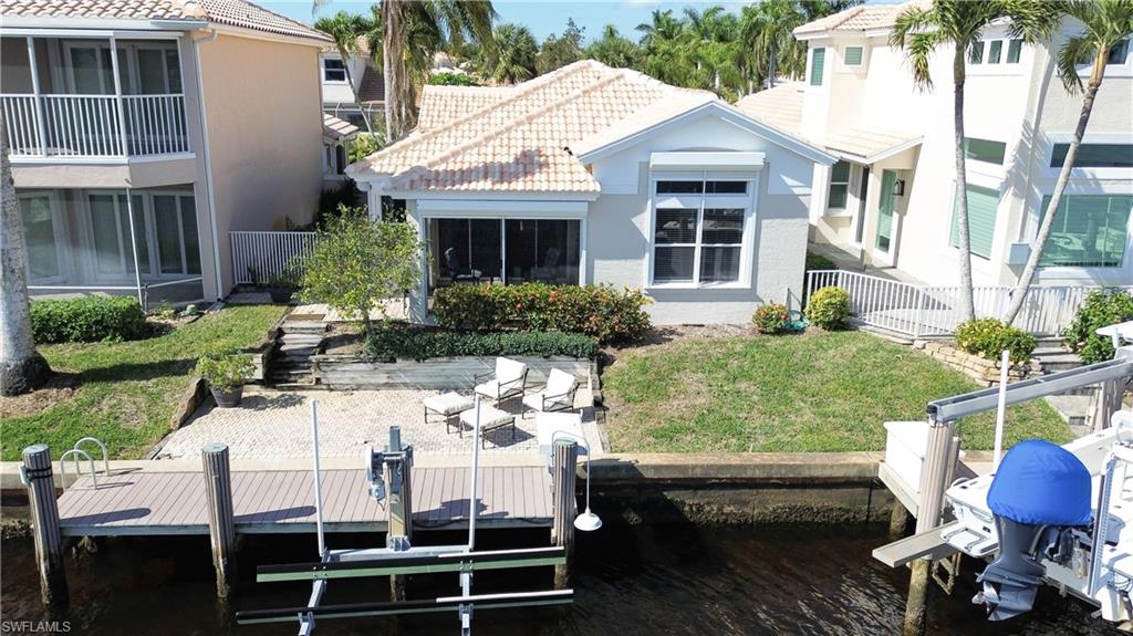 162 Eveningstar Cay Naples, FL 34114 - Photo 23 of 32 a view of house with a yard and sitting area