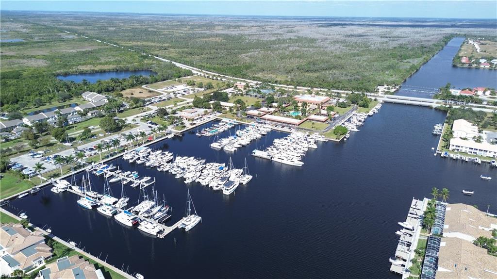 162 Eveningstar Cay Naples, FL 34114 - Photo 32 of 32 an aerial view of a house with a lake view