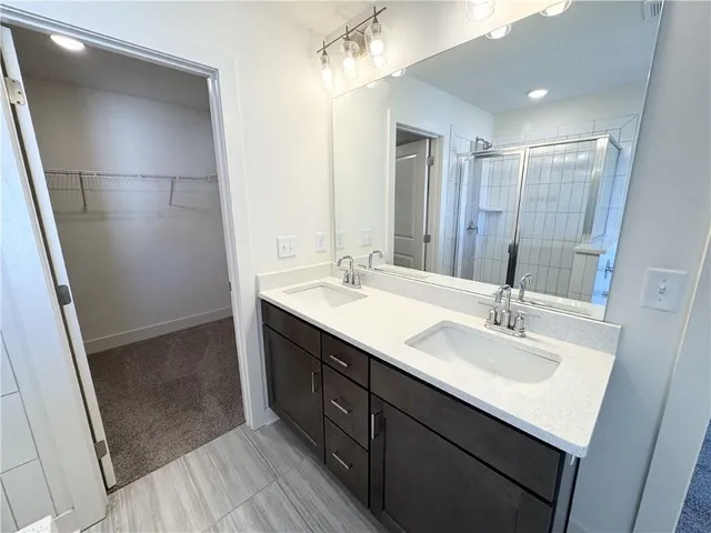 a bathroom with double vanity sink and a mirror