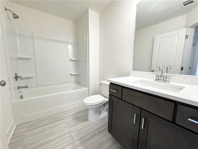 a bathroom with a sink a toilet and a bathtub