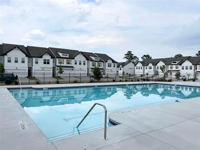 a view of a house with swimming pool and porch