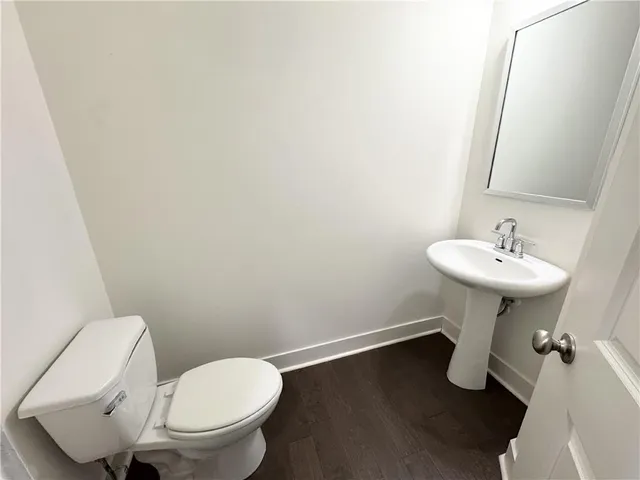 a bathroom with a sink toilet and a mirror