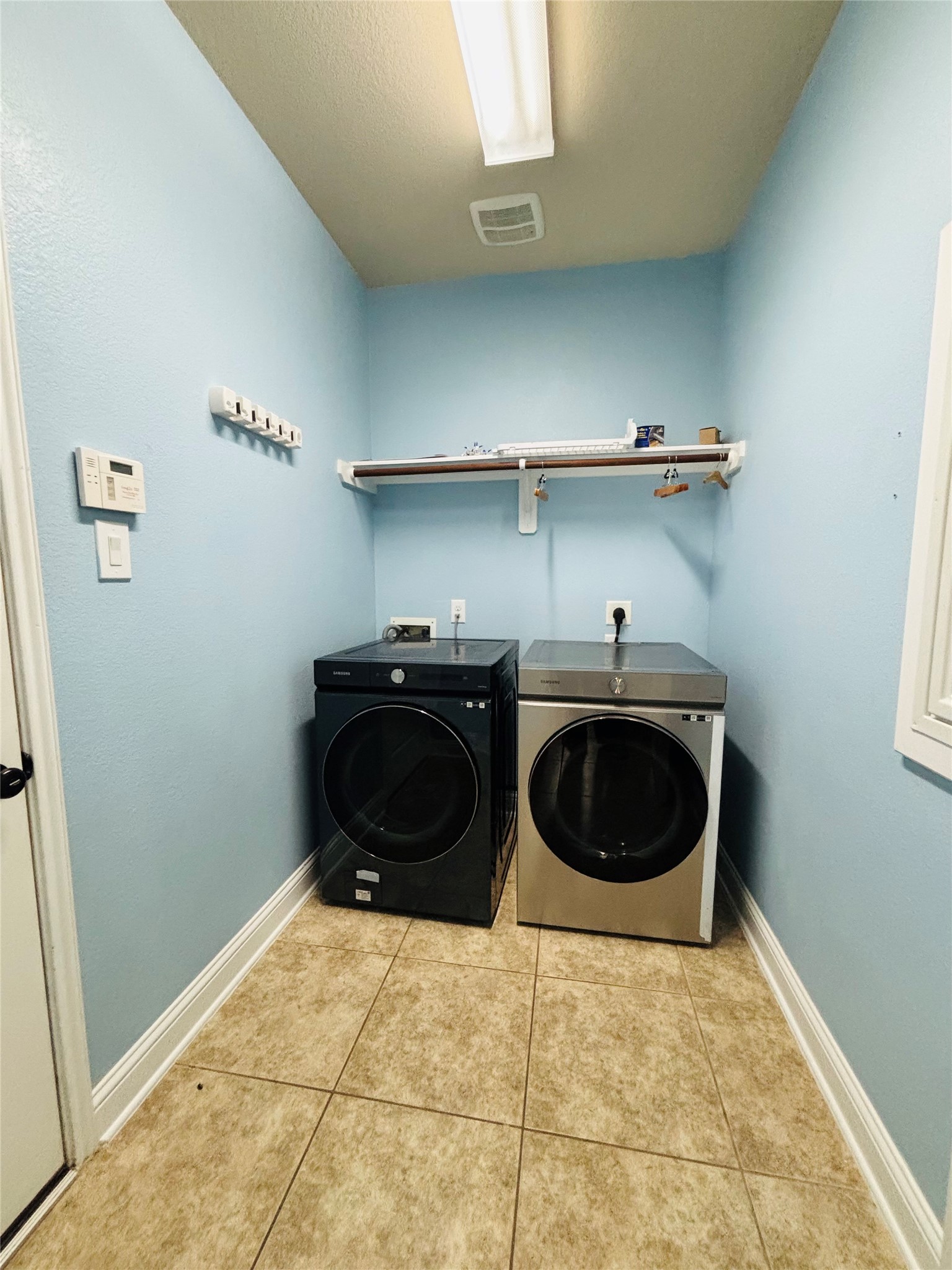 419 Blossom Terrace Lane Rosenberg, TX 77469 - Photo 16 of 19 a room with a washing machine and cabinets