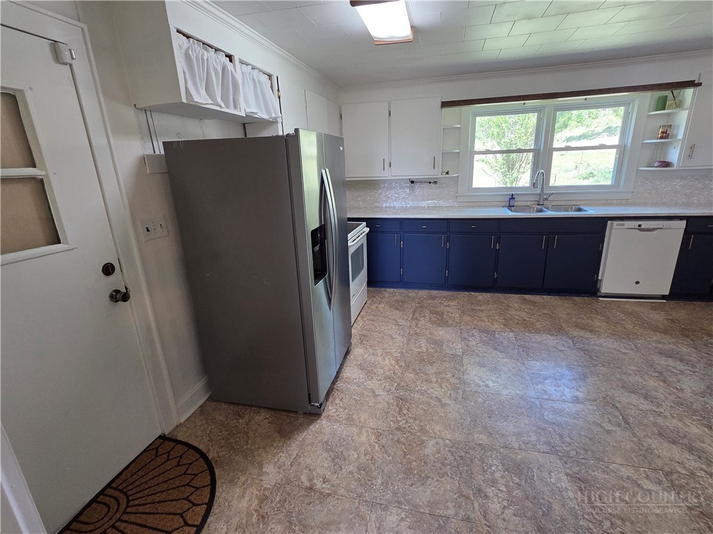145 Black Oak Ridge Road Taylorsville, NC 28681 - Photo 14 of 39 a kitchen with stainless steel appliances a refrigerator and a sink