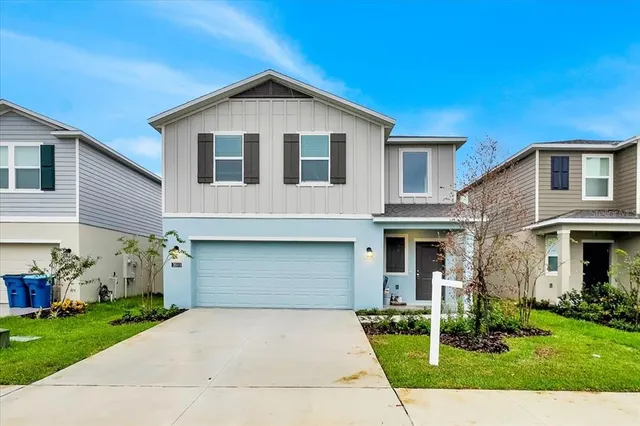 a front view of a house with a yard and garage