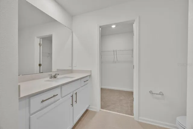 a bathroom with a granite countertop sink a toilet and shower