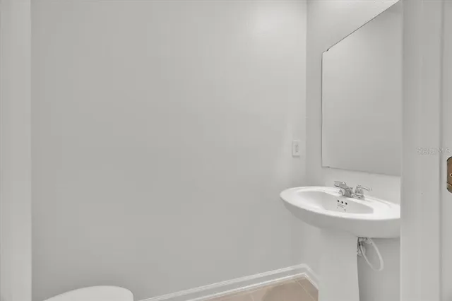 a bathroom with a sink a mirror and a toilet