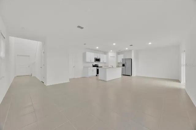 a view of a kitchen with a sink and a refrigerator
