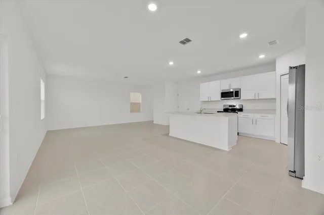 a view of kitchen with white cabinets