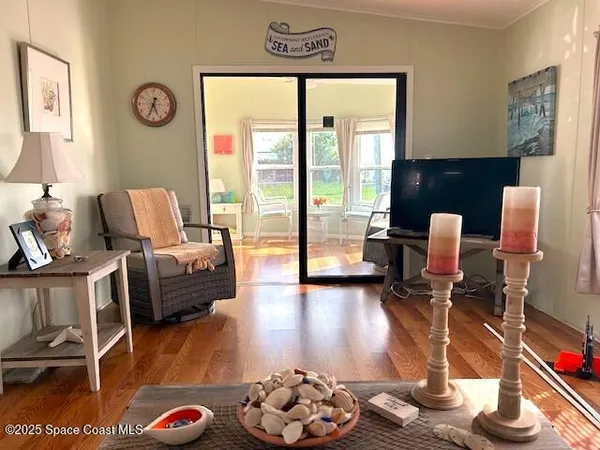 a living room with furniture and a wooden floor